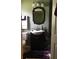 Bathroom featuring a black vanity, modern mirror and toilet at 808 Ware Ne Ave, Winter Haven, FL 33881