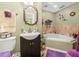 Bathroom features a vanity with dark wood cabinetry and a tiled backsplash at 808 Ware Ne Ave, Winter Haven, FL 33881