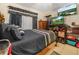 Bedroom features hardwood bed frame, dark bedding, and dark curtains at 808 Ware Ne Ave, Winter Haven, FL 33881