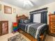 Bedroom features hardwood bed frame, dark bedding, and dark curtains at 808 Ware Ne Ave, Winter Haven, FL 33881