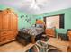 Well-lit bedroom with tile floor, ceiling fan, and a decorative area rug at 808 Ware Ne Ave, Winter Haven, FL 33881