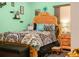 A bedroom featuring an ornate wooden bed frame with blue and gray patterned bedding at 808 Ware Ne Ave, Winter Haven, FL 33881