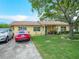 This house has a well-manicured lawn and a driveway with space for two cars at 808 Ware Ne Ave, Winter Haven, FL 33881