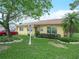 Quaint home with lush green lawn, stone accents, and a well-manicured garden bed at 808 Ware Ne Ave, Winter Haven, FL 33881