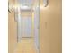 Hallway with tile floors, white doors, and neutral walls, offering a clean and bright passage at 808 Ware Ne Ave, Winter Haven, FL 33881