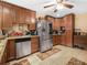 The kitchen has wooden cabinets, stainless steel appliances, and neutral tile floors at 808 Ware Ne Ave, Winter Haven, FL 33881