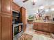 The kitchen features stainless steel appliances, granite countertops, wooden cabinets, and open access to the living spaces at 808 Ware Ne Ave, Winter Haven, FL 33881
