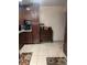 Traditional kitchen featuring tile floors, brown cabinets, and decorative rugs at 808 Ware Ne Ave, Winter Haven, FL 33881
