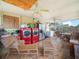 Bright laundry room features a red washer and dryer with tile floors and wicker furniture at 808 Ware Ne Ave, Winter Haven, FL 33881