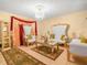 Ornate living room featuring high-backed white and gold chairs, mirrored table and chandelier at 808 Ware Ne Ave, Winter Haven, FL 33881