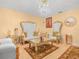 A formal living room featuring ornate seating arrangement with gold trim and an elegant chandelier at 808 Ware Ne Ave, Winter Haven, FL 33881