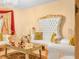 Elegant living room featuring white and gold chairs, a mirrored table and chandelier lighting at 808 Ware Ne Ave, Winter Haven, FL 33881