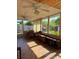 Relaxing sunroom featuring tile flooring and two ceiling fans at 808 Ware Ne Ave, Winter Haven, FL 33881