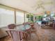 Enclosed sunroom featuring wicker furniture, ceiling fans, and tiled flooring at 808 Ware Ne Ave, Winter Haven, FL 33881