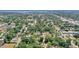 Areal shot of the neighborhood with mature trees, businesses and lake in the distance at 825 Augusta St, Lakeland, FL 33805