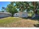 Backyard with a grassy lawn and a building behind a chain-link fence at 825 Augusta St, Lakeland, FL 33805