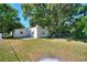 Spacious backyard with large trees, grassy lawn, and chain-link fence at 825 Augusta St, Lakeland, FL 33805
