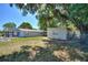 Spacious fenced backyard offering ample green space and mature trees for shade and privacy at 825 Augusta St, Lakeland, FL 33805