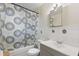 Bright bathroom featuring a tub with shower curtain, toilet, and vanity sink at 825 Augusta St, Lakeland, FL 33805
