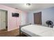 Simple bedroom with light pink walls, a full bed, and basic furnishings at 825 Augusta St, Lakeland, FL 33805