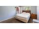 Bedroom with carpet, with a wooden bed, and a white door to the outside at 825 Augusta St, Lakeland, FL 33805