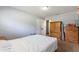 A bedroom with a white ceiling and blue walls with a wooden dresser and bed at 825 Augusta St, Lakeland, FL 33805