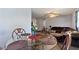 Bright dining area featuring a glass-top table set for four connected to cozy living room at 825 Augusta St, Lakeland, FL 33805