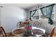 Bright dining area featuring a glass-top table set for four, illuminated by natural light from the window at 825 Augusta St, Lakeland, FL 33805