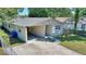 Cozy single story home featuring a carport and a well-maintained front yard at 825 Augusta St, Lakeland, FL 33805