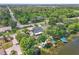 Scenic aerial view of a lakefront property showcasing lush landscaping, boat docks, and a serene atmosphere at 9950 W Lake Marion Rd, Haines City, FL 33844