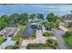 Beautiful aerial shot of lakefront home with solar panels, lush landscaping, and a long private driveway at 9950 W Lake Marion Rd, Haines City, FL 33844
