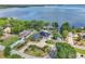 Breathtaking aerial view of lakefront house featuring solar panels, a spacious yard, and stunning water views at 9950 W Lake Marion Rd, Haines City, FL 33844