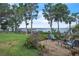 A manicured backyard features a scenic lake view and charming seating area at 9950 W Lake Marion Rd, Haines City, FL 33844