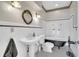 Charming black and white bathroom with a pedestal sink, claw foot tub, and classic fixtures at 9950 W Lake Marion Rd, Haines City, FL 33844