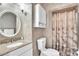 Bathroom with a vanity, toilet, and a shower with neutral tile and glass door at 9950 W Lake Marion Rd, Haines City, FL 33844