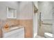Neutral tiled bathroom with a granite countertop vanity and accessible shower at 9950 W Lake Marion Rd, Haines City, FL 33844