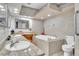 Luxurious bathroom with dual sinks, a soaking tub, and elegant tile work at 9950 W Lake Marion Rd, Haines City, FL 33844