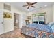 Comfortable bedroom with ceiling fan, view to the ensuite bathroom, and bright neutral colors at 9950 W Lake Marion Rd, Haines City, FL 33844