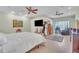Spacious bedroom featuring tile floors, a TV, and a gorgeous view of the water at 9950 W Lake Marion Rd, Haines City, FL 33844