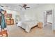 Cozy bedroom featuring neutral walls, tile floors, and an en suite bathroom at 9950 W Lake Marion Rd, Haines City, FL 33844