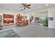 Open-concept dining room boasts decorative shelving and seamless transition to the living room and kitchen at 9950 W Lake Marion Rd, Haines City, FL 33844
