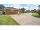 View of a brick house with a circular brick driveway and manicured front lawn at 9950 W Lake Marion Rd, Haines City, FL 33844