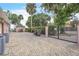 Large brick driveway leading to a gated property with mature landscaping and an outdoor shed at 9950 W Lake Marion Rd, Haines City, FL 33844