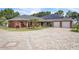 Stunning single-story home featuring a beautifully paved circular driveway, solar panels, and a two-car garage at 9950 W Lake Marion Rd, Haines City, FL 33844