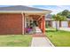 View of the home's exterior featuring a covered front porch adorned with plants, creating an inviting entrance at 9950 W Lake Marion Rd, Haines City, FL 33844
