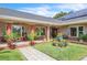 Inviting covered front porch with decorative plants and flowers creating a welcoming entrance to the home at 9950 W Lake Marion Rd, Haines City, FL 33844