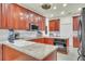 Cozy kitchen shows wooden cabinets, granite countertops, and stainless steel appliances at 9950 W Lake Marion Rd, Haines City, FL 33844