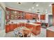 Charming breakfast nook features wooden cabinets with glass doors, granite countertops, and modern appliances at 9950 W Lake Marion Rd, Haines City, FL 33844