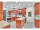 Well-lit kitchen with wooden cabinets, granite countertops, and modern appliances at 9950 W Lake Marion Rd, Haines City, FL 33844