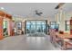 Expansive living space featuring tile floors, recessed lighting, and sliding glass doors with views of water at 9950 W Lake Marion Rd, Haines City, FL 33844